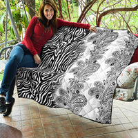 Black-and-white quilt shown draped, with zebra stripes and paisley print blocks.