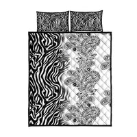 Quilt bed set with zebra-striped pillowcases and a quilt with gray paisley center