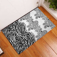 Bordered rubber doormat with zebra stripes and ornate paisley medallions on white.