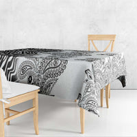 White tablecloth with black zebra and paisley motifs, hanging over table edges