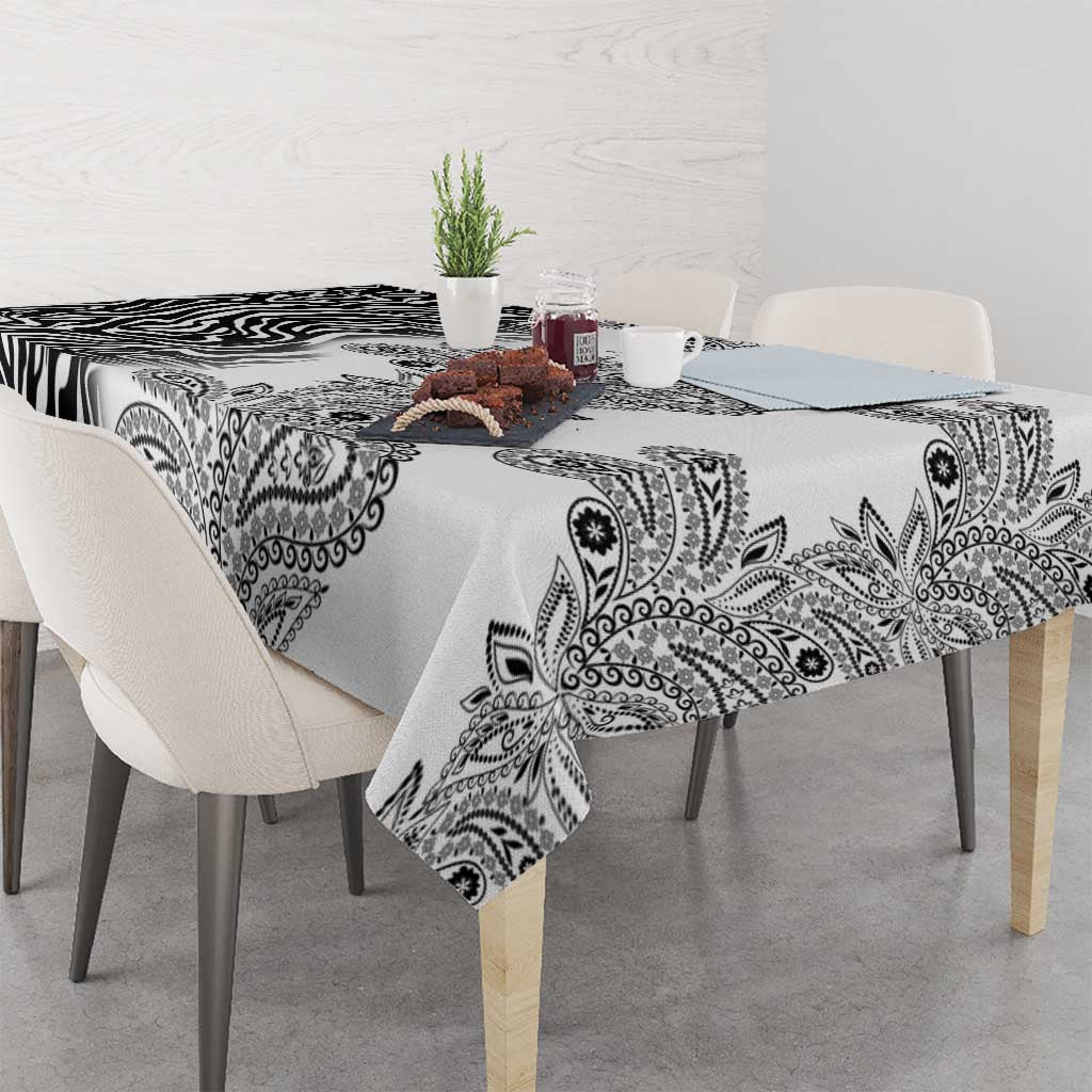 White tablecloth with black paisley and zebra pattern, draped over dining table