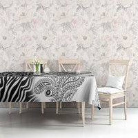 White and black paisley and zebra tablecloth, neatly set on dining table