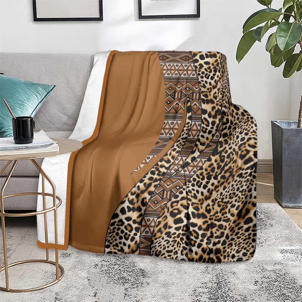 Leopard and geometric tribal blanket with tan solid panel, draped across a couch.