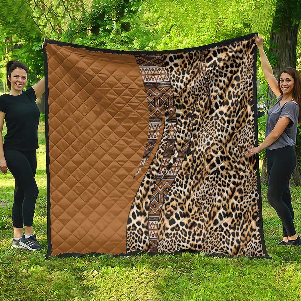 Tan and leopard-print quilt with a black tribal geometric stripe down the center