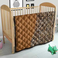 Quilt on a child bed: tan solid quilted panel with leopard-print corner and tribal stripe