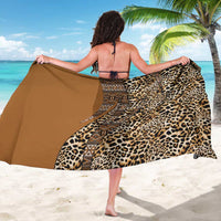 Gold leopard print sarong with tribal stripe panel, worn and draped open