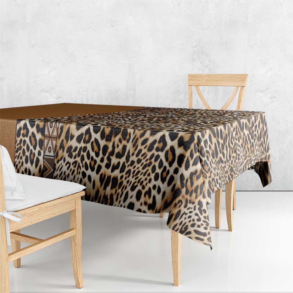 Leopard print tablecloth with dark tan border draped over dining table