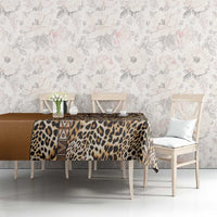 Gold and dark tan leopard tablecloth with tribal detail, draped on bench table