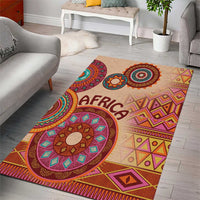 Beige tribal area rug with “AFRICA” lettering, concentric medallions, geometric borders