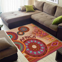 Beige tribal area rug with large circular medallion and “AFRICA” lettering