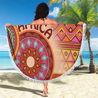 Round beach blanket featuring vibrant African tribal motif print and white fringe border.