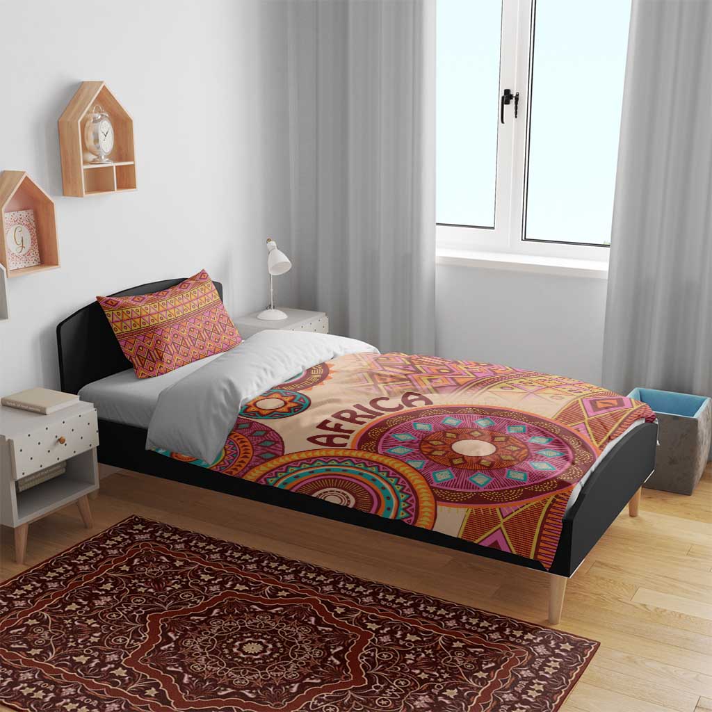 Beige African tribal bed cover set with vibrant circular medallion motif and two pillow shams