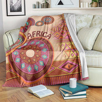 Beige tribal pattern blanket with 'AFRICA' text and multicolor circular motifs, geometric trim