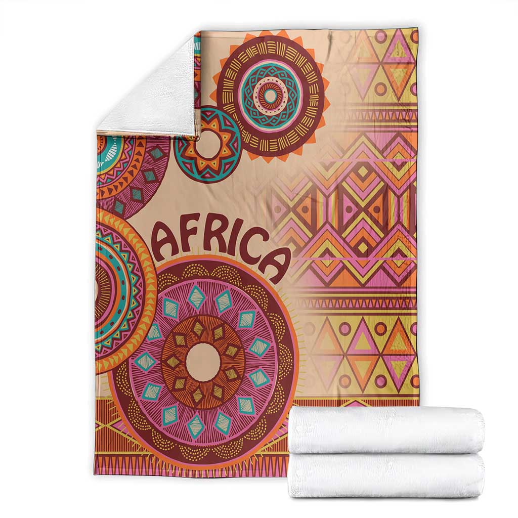 Beige folded Africa tribal pattern blanket with 'AFRICA' and multicolor circular motifs, geometric trim