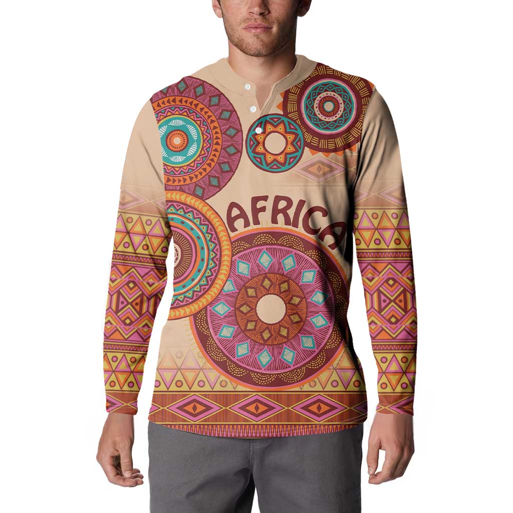 Beige tribal button sweatshirt worn by model, front graphic with circular patterns and text