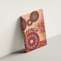 Angled beige canvas wall art with 'AFRICA' text and colorful circular tribal motifs.
