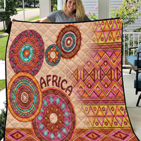 Beige quilt with colorful circular tribal motifs and 'Africa' text, quilted fabric