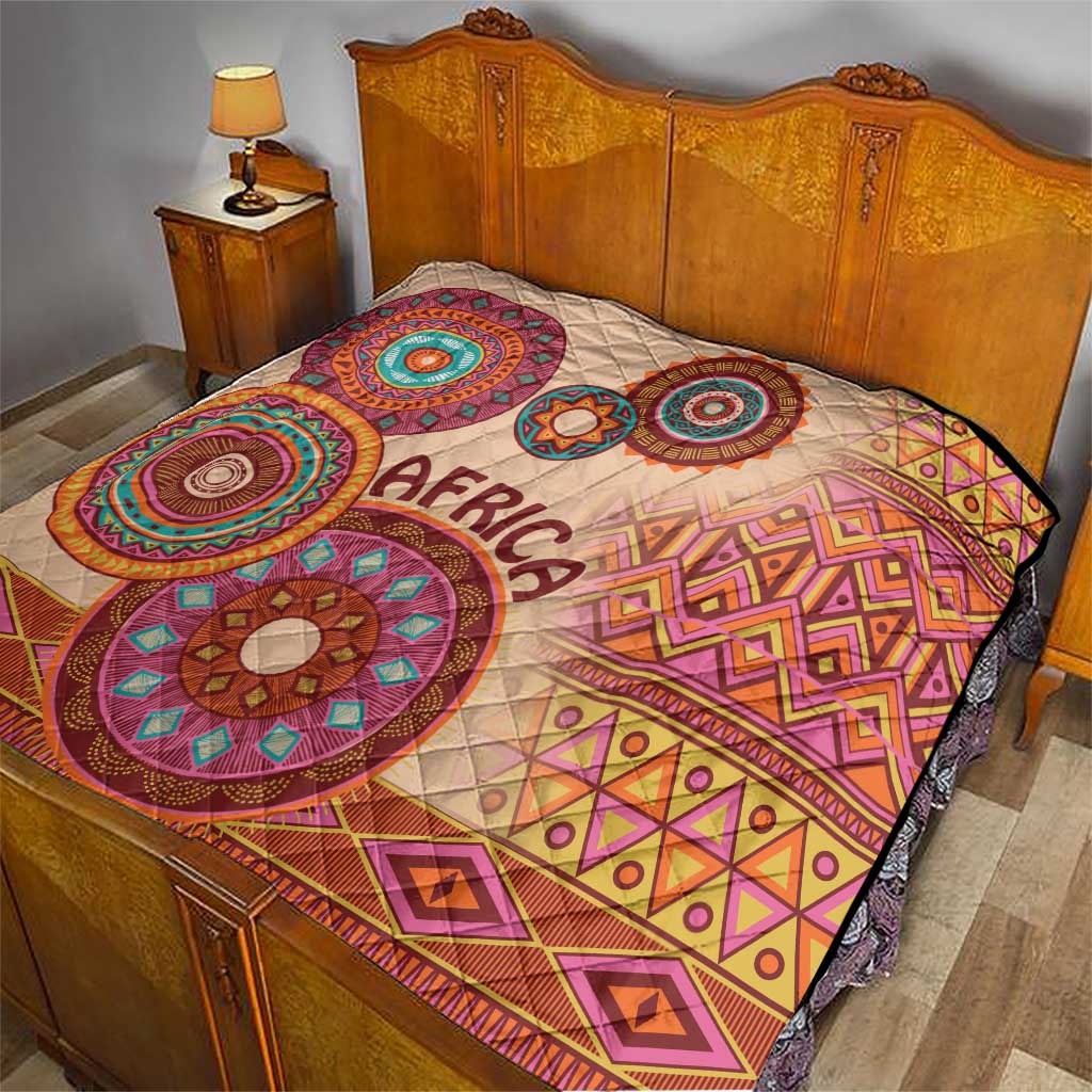 Beige bed quilt with 'Africa' center, large circular tribal prints and diamond borders