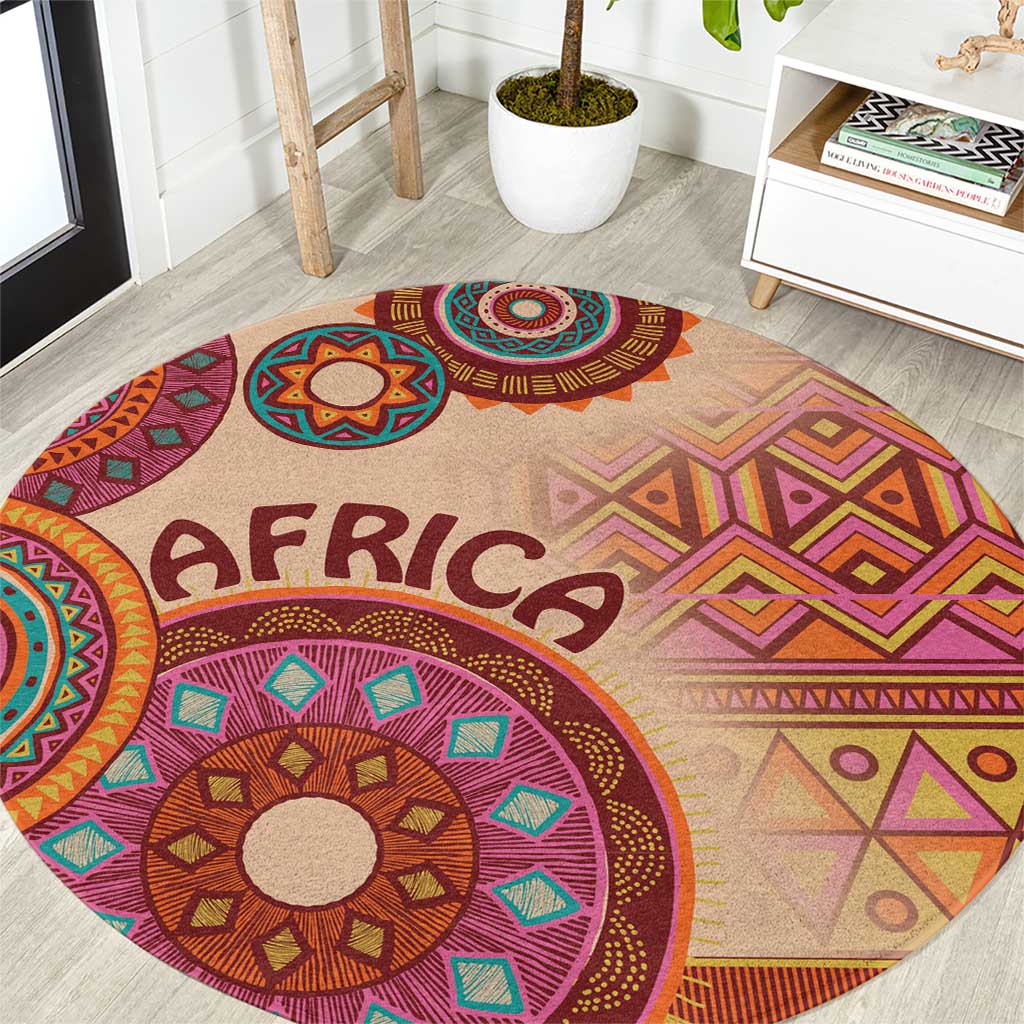 Round area rug with purple and orange tribal mandala motifs on beige background