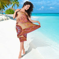 Beige tribal sarong with geometric multicolor pattern and medallion motif, fringed hem