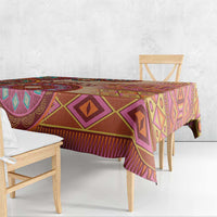 Geometric tribal patterned tablecloth with purple and orange motifs, beige base.