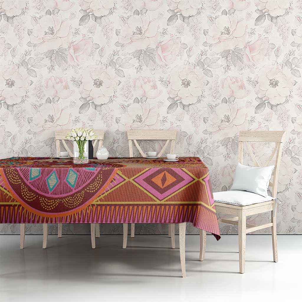 Tribal patterned tablecloth with diamond and arch motifs in purple, orange, beige.