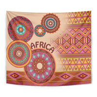 Beige tapestry close-up: multicolor circular medallions, 'AFRICA' text, geometric patterns