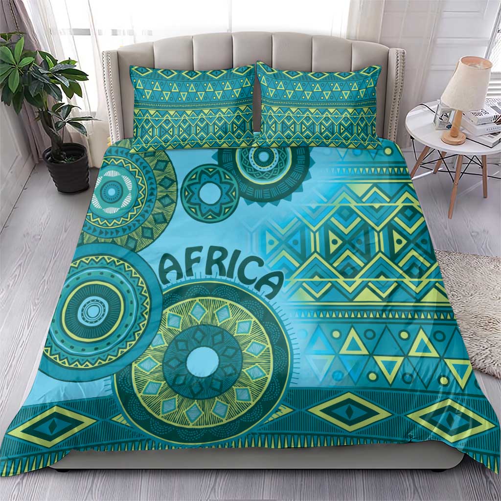 Turquoise tribal bedding set with "AFRICA" print and geometric bands on duvet and pillows