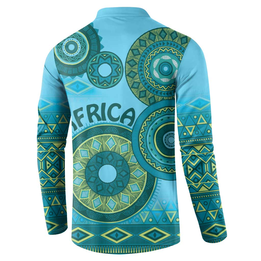 Back of blue button-up sweatshirt with green tribal circular design and patterned sleeves