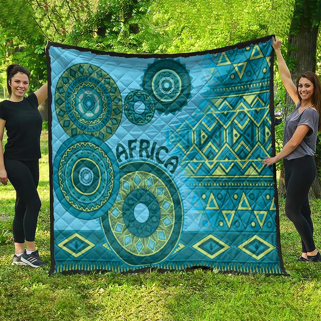 Large blue tribal quilt blanket with circular teal motifs, geometric diamonds, and “Africa”.