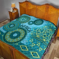 Blue tribal quilt bedding with circular teal motifs, diamond accents, and “Africa” lettering.