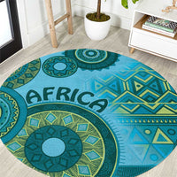 Blue round tribal pattern rug with teal medallions, geometric motifs, and “AFRICA” print