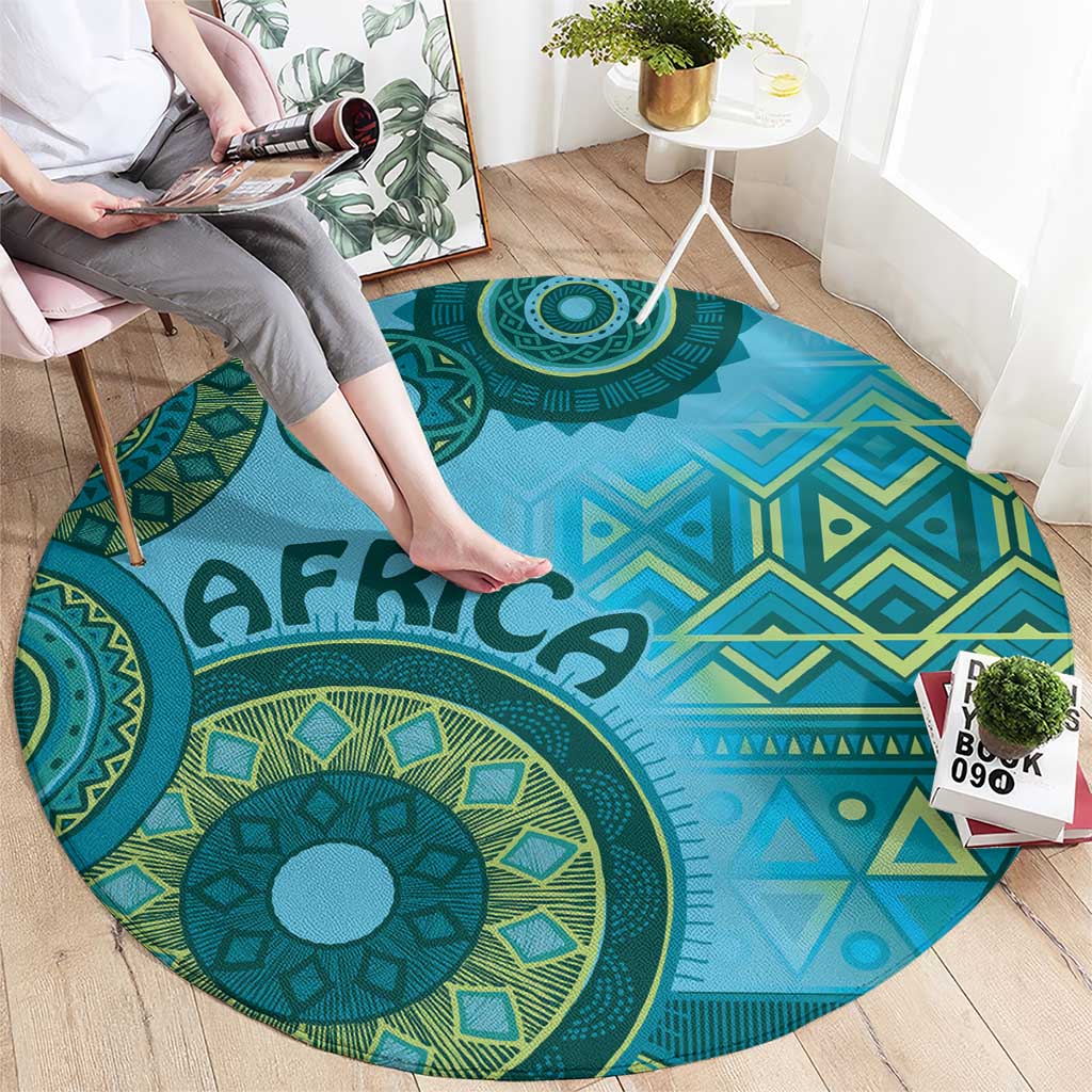 Blue round tribal pattern rug with bold medallion design, geometric shapes, and “AFRICA”