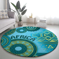 Blue round tribal pattern rug with large teal floral medallion and geometric border