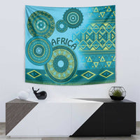 Blue tribal pattern tapestry with circular designs, zigzag bands, and fringed bottom edge