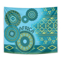 Blue tribal patterned tapestry close-up with large circular motifs, geometric bands, and fringe