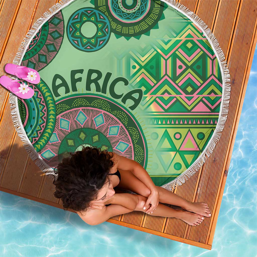 Round green beach blanket with bold tribal pattern and 'AFRICA' word, white fringe edge