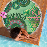 Round green beach blanket with bold tribal pattern and 'AFRICA' word, white fringe edge