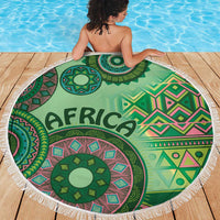 Round beach blanket with green tribal pattern, 'AFRICA' lettering, multicolor accents