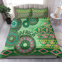 Green tribal bedding set on bed with duvet and two pillowcases, 'AFRICA' center motif
