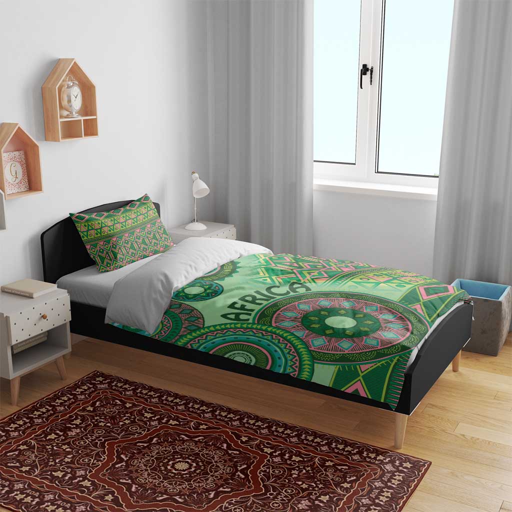 Green tribal patterned bedding set with circular motifs and bold 'AFRICA' text on duvet