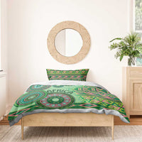 Green tribal bedding set duvet with circular medallion and 'AFRICA' lettering, on bed