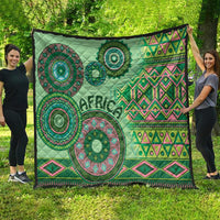 Green tribal pattern quilt with circular mandalas, zigzag bands, and dark edge border