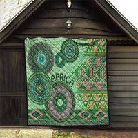 Green tribal quilt with quilted texture, circular mandala motifs, and pink geometric edge border