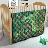 Green tribal quilt on a wooden crib, circular motifs, pink geometric zigzags, and "AFRICA"