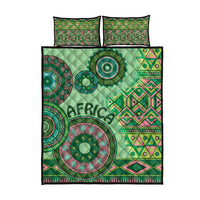 Green tribal quilt bed set with circular designs and two pillow covers, front view