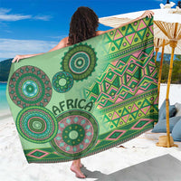 Green tribal-pattern sarong with circular medallions and 'AFRICA' text