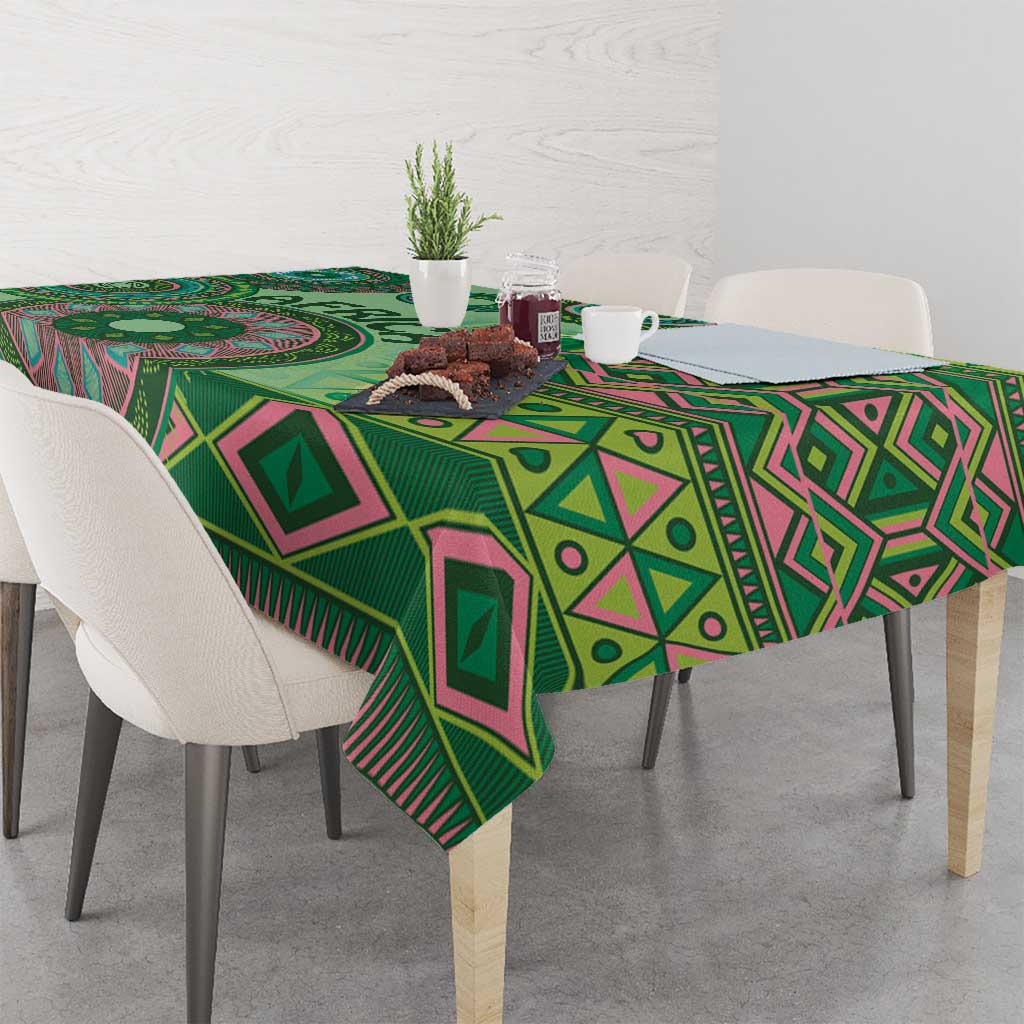 Green tribal pattern tablecloth with geometric diamonds and stripes, draped over table
