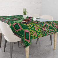 Green tribal pattern tablecloth with geometric diamonds and stripes, draped over table