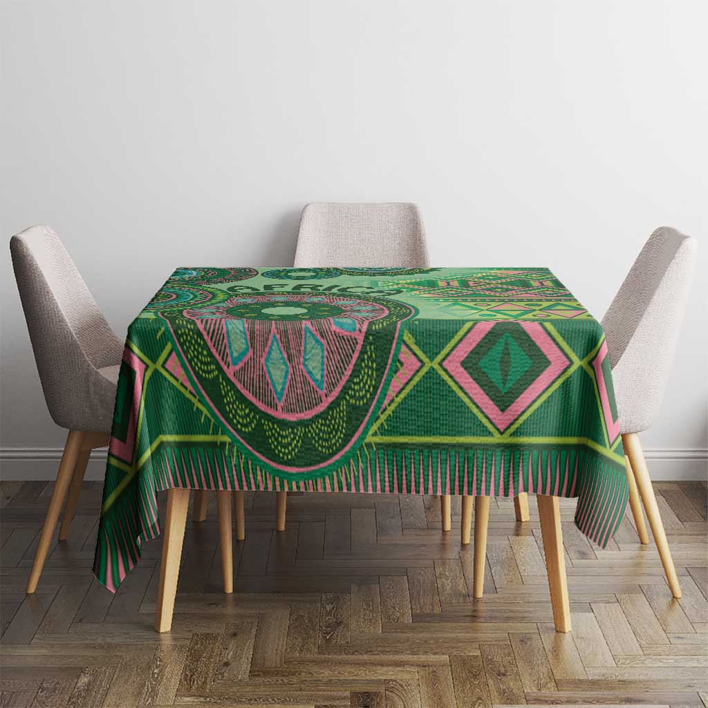 Green tribal patterned tablecloth with diamond shapes and fringed edge